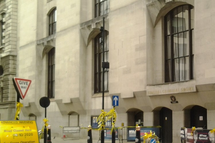 Old Bailey, London, with yellow ribbons tied on lampposts and banners in support of Julian Assange