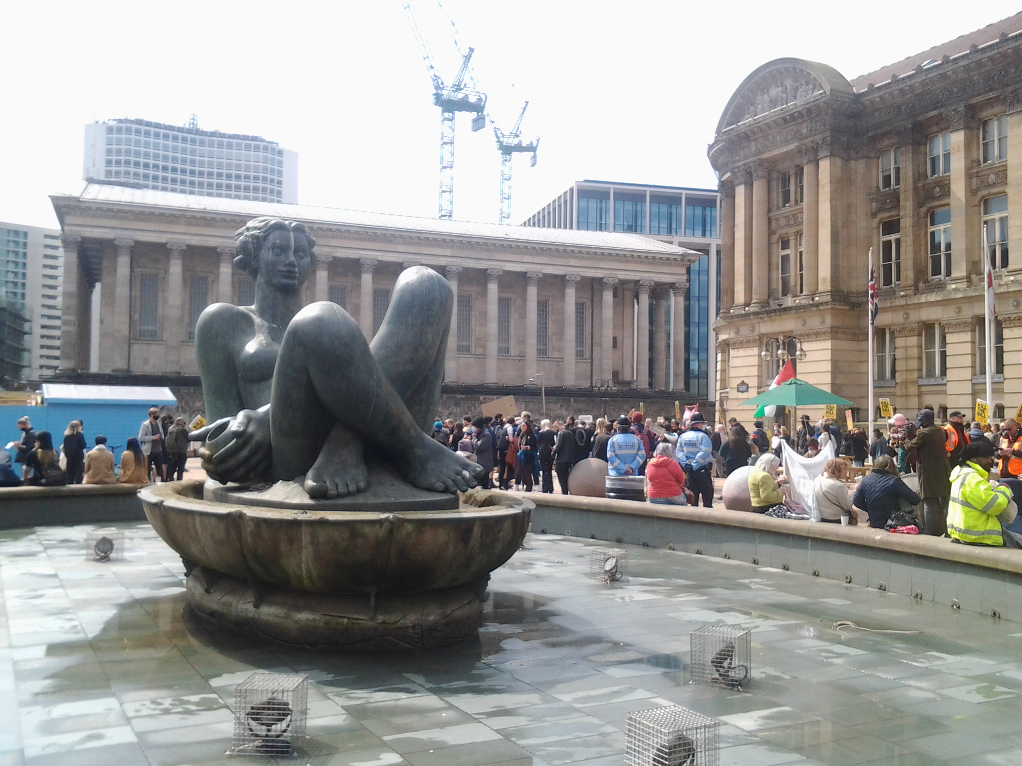 Image of Victoria Square Birmingham with protesters in background