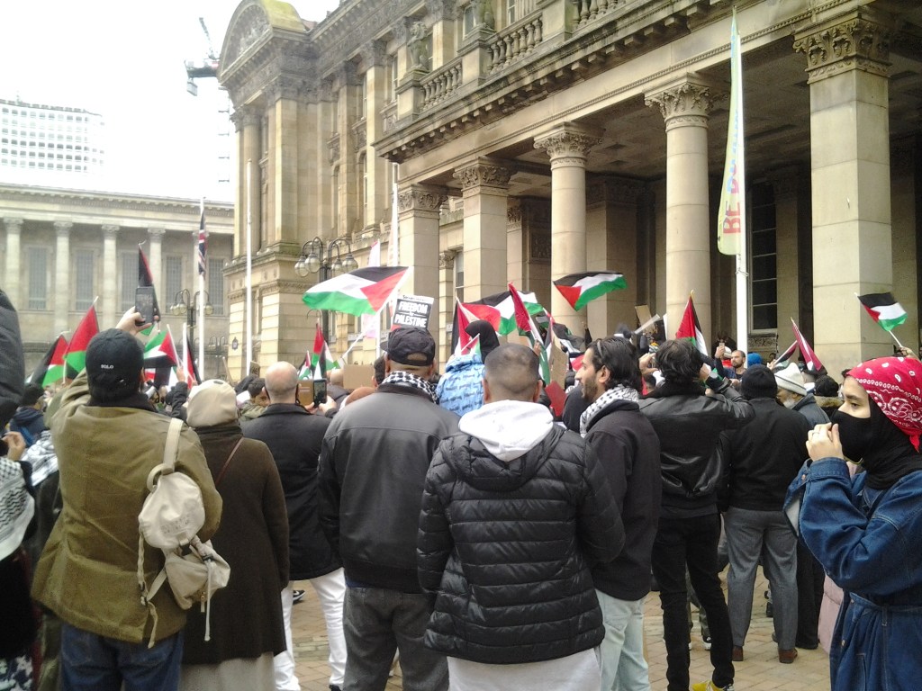 Protesters in Victoria Square with Palestine Flags.