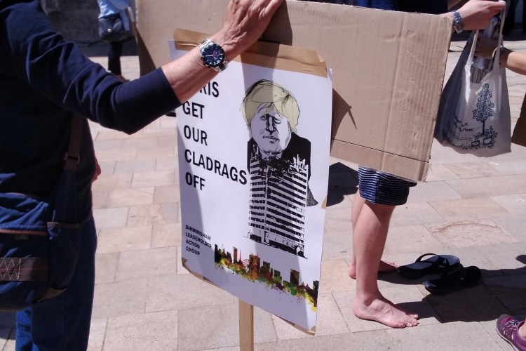 Sign reading Boris Get our Cladrags off with a caricature of Boris Johnson