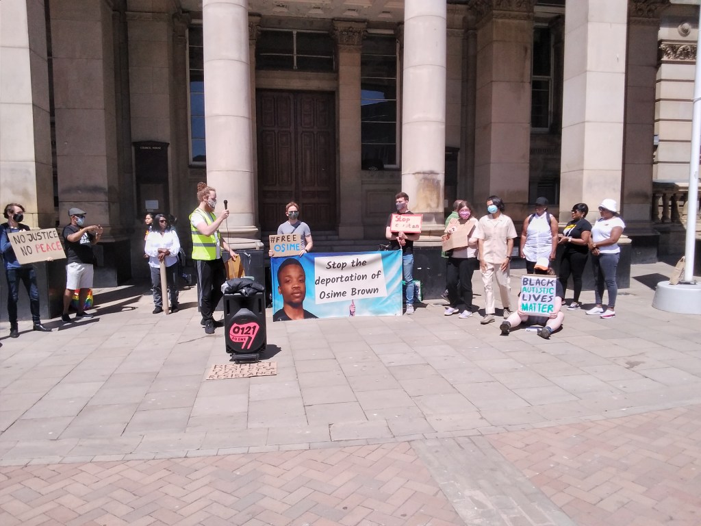 Protesters with signs reading "Stop the Deportation of Osime Brown.", "No Justice, No Peace", "Black Autistic Lives Matter".