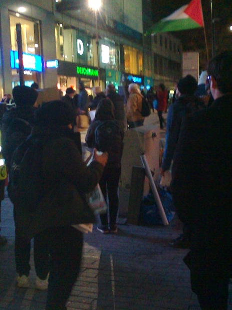 Protesters in the dark.