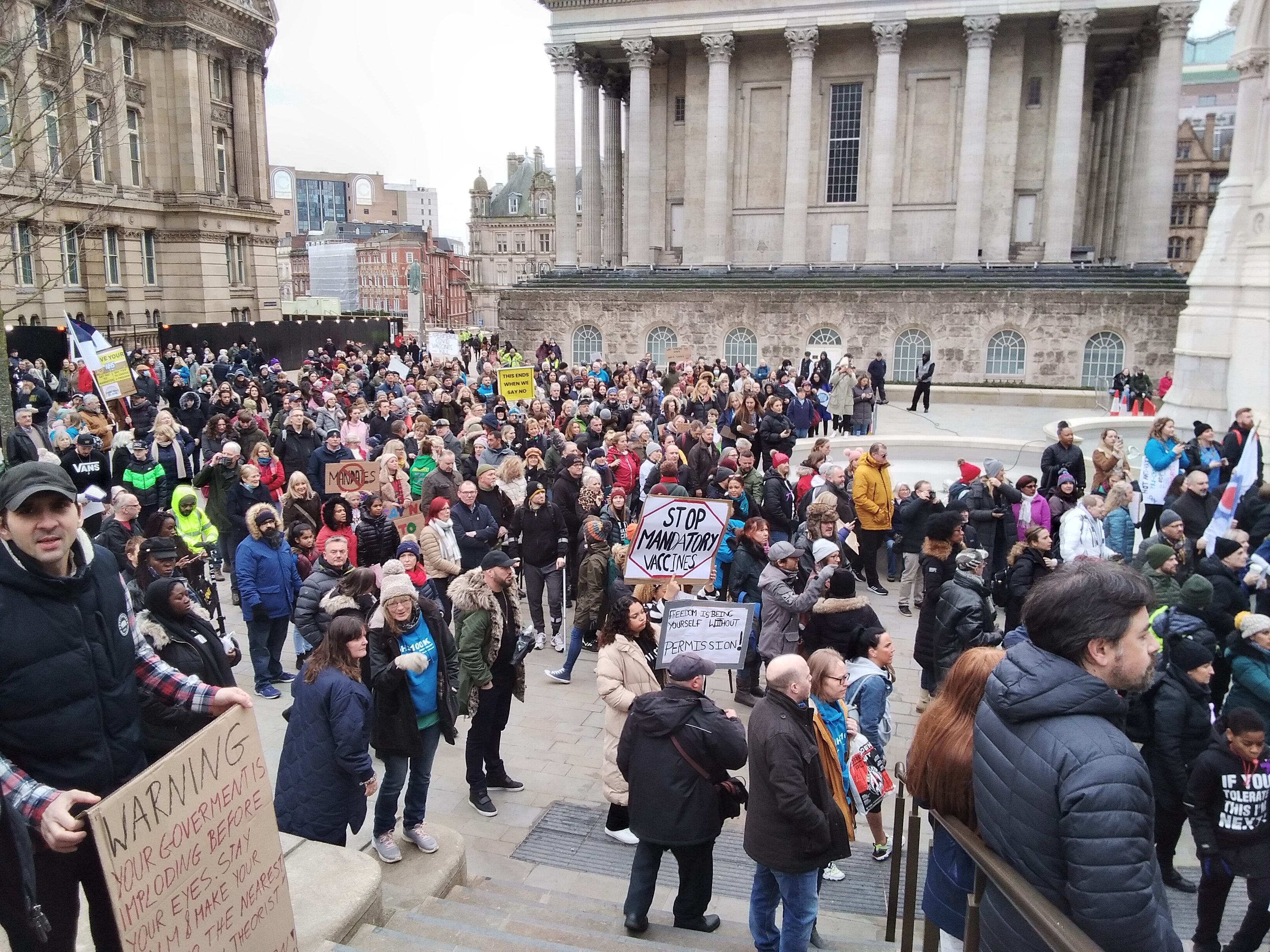 Large number of protesters, sign in front says No Mandatory vaccines.