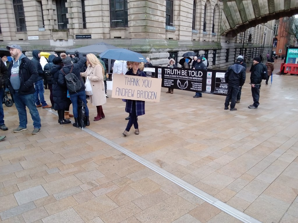 Woman holding sign reading "Thank You Andrew Bridgen"